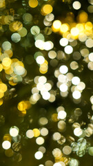 Defocused string lights on christmas tree, shiny gold yellow blurred bokeh circle background wallpaper for festive season celebration. 