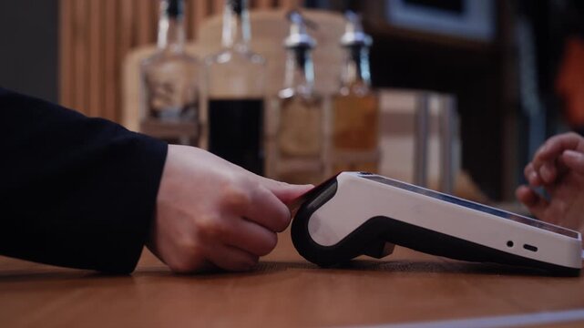 Person paying with a credit card using the contactless nfc system and fingerprint authentication