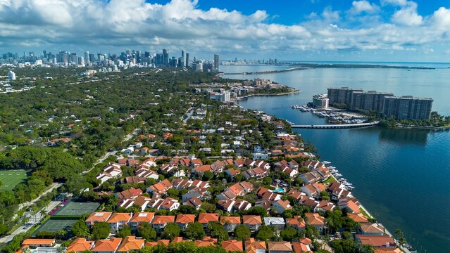 Aerial view of coastal homes with Miami downtown in the background - Powered by Adobe