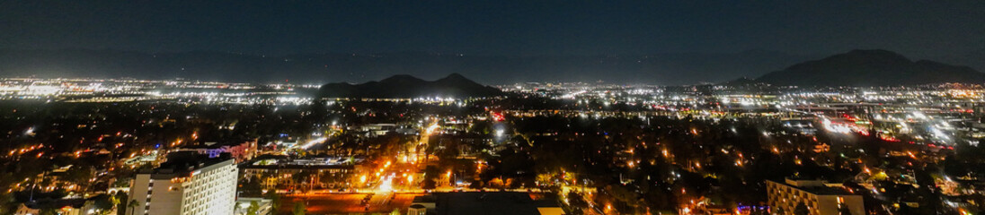The Night Lights of Downtown Riverside, California from  a UAV Drone Aerial view with the horizon in the background during the Christmas Holiday Season.