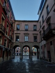 Fototapeta premium Main square of the tourist city of Gijon with its classic buildings and stone arches surrounding the square, Asturias. 
