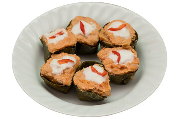 Thai steamed curry (Hor Mok) served in a small leaf cup on a white plate, isolated on transparent background.
