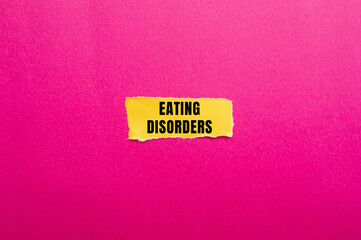 Eating Disorders message written on ripped torn paper background. Conceptual Eating Disorders symbol. Copy space.