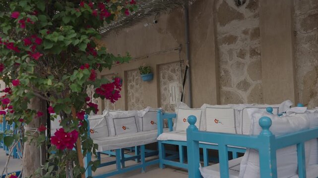 Traditional Outdoor Seating Area with Blue Benches and Flowers