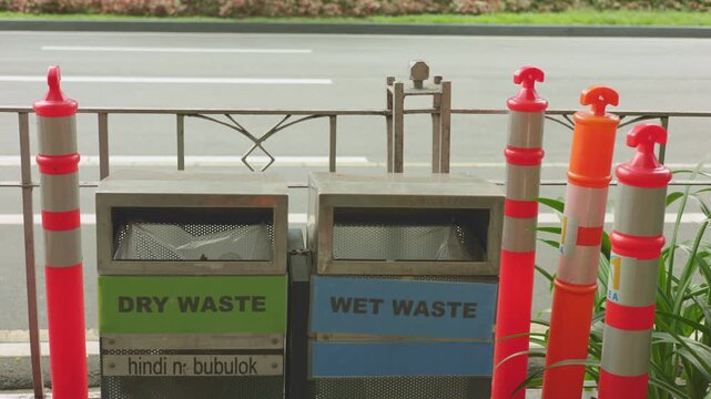 Urban waste management, public safety and recycling infrastructure, city street waste disposal and transportation safety, streetside waste containers emphasizing safety and ecological responsibility