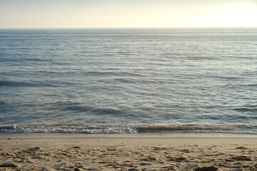 Beach view in North Sumatra. Front view of a summer travel landscape, the sea, the cool waves, and the calm sea on vacation in a coastal area. The reflection of the afternoon sun on the beach water.