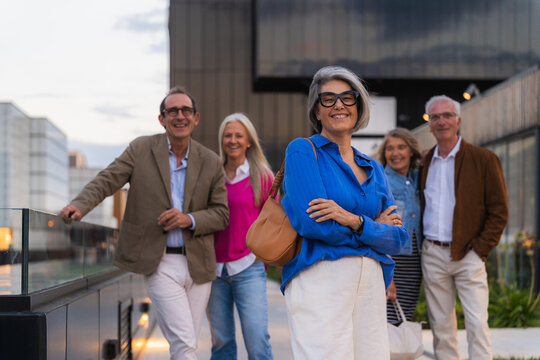 Senior friends spending time together outdoors, feeling happy and confident