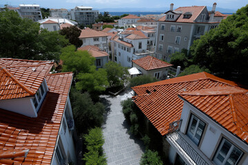 Obraz premium Houses with red roofs and green trees in town under bright sky