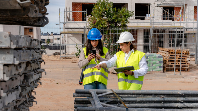 Architect and engineer collaborating on a construction site