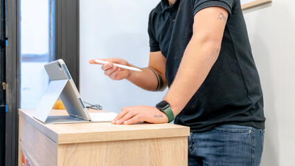 Barber using digital technology in modern shop