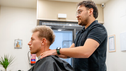Barber offering massage in a modern barbershop setting