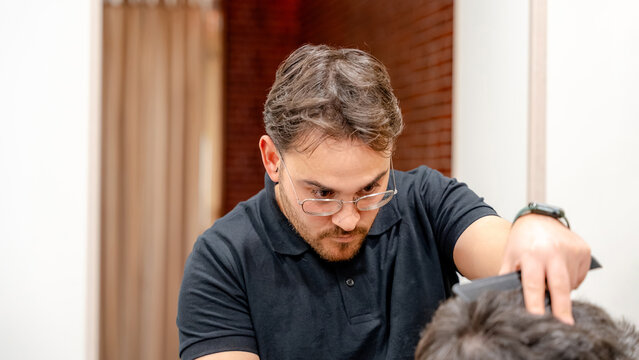 Skilled barber focusing on a precise haircut