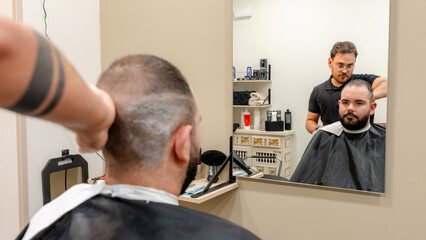Barber giving a haircut in modern barbershop