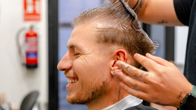 Man enjoying haircut at modern barbershop