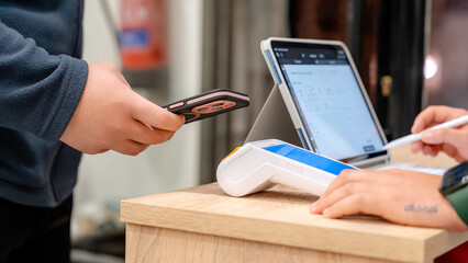 Mobile payment at a modern barbershop counter
