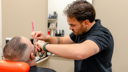 Barber offering precision beard trim with care