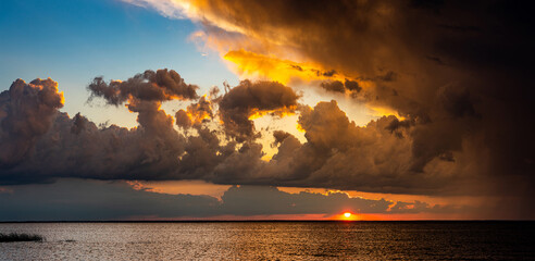 Panoramic seascape with dramatic stormy sky and sun rays