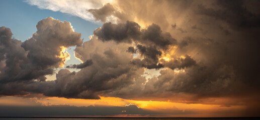Panoramic seascape with dramatic stormy sky and sun rays