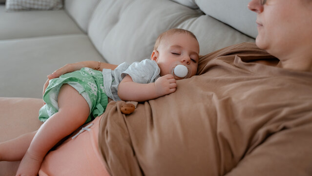 Sleeping baby on parent's chest in a comforting embrace