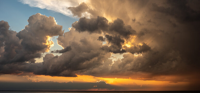 Panoramic seascape with dramatic stormy sky and sun rays - Powered by Adobe