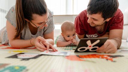 Family bonding with baby using high-contrast cards