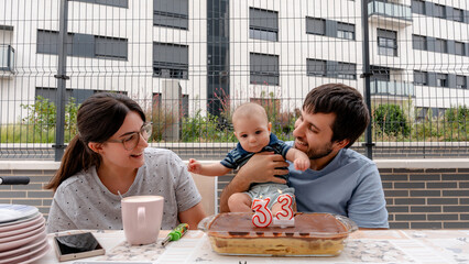 Family celebrating a birthday with baby outside