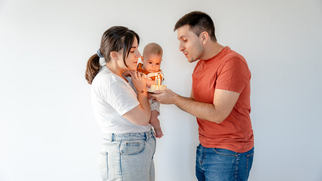 Family celebrating baby's milestone with cake