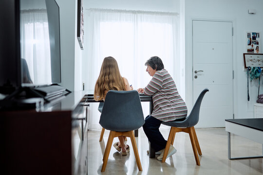 Grandmother and teenager bonding at home