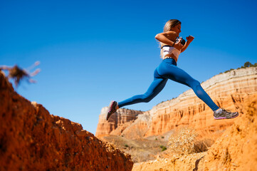 Adventurous leap in the breathtaking Red Canyon, Spain