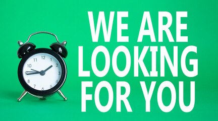 Tell us what you think symbol. Wooden blocks with words Tell us what you think. Beautiful green background with alarm clock. Business and Tell us what you think concept. Copy space.