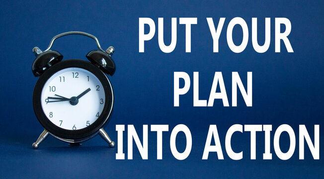 Put your plan into action symbol. Concept words Put your plan into action on white puzzle. Beautiful white background with alarm clock. Business concept and Put your plan into action. Copy space.