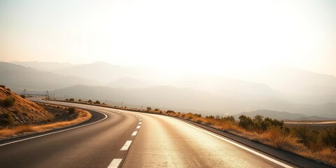 Naklejka premium Asphalt ribbon vanishing into hazy distance, sun-drenched landscape, clouds, stripes