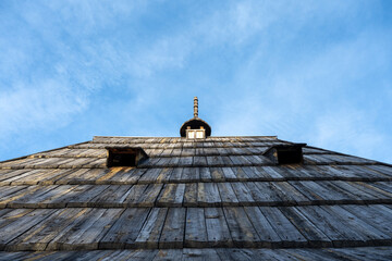 An artistic perspective looking upward along the steep slope of a hand-crafted wooden rooftop....
