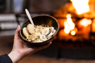 Healthy breakfast bowl enjoyed by fireplace warmth