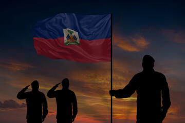 Military mans holds in their hands National flag of Haiti