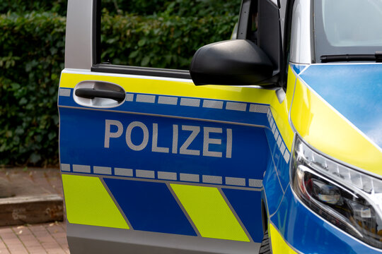 The open door of a German police car with the sign "Polizei." Background for breaking news, events, incidents, breaking news, traffic accidents, fires, and city news.