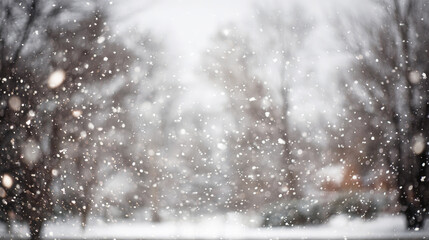 Heavy snow falling with soft focus on a winter forest background, creating a serene and dreamy seasonal atmosphere full of motion and texture. Blurred image.