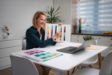 Woman making video call showing color swatches for design work