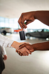 Handshaking on new car purchase agreement delivery