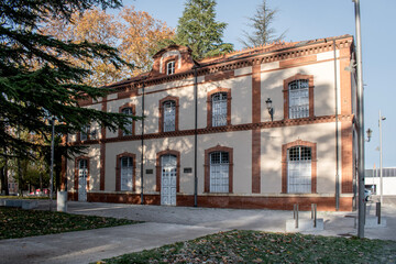 19th century building of the old Palencia train station, located in some gardens
