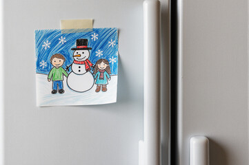 A joyful winter scene featuring a young boy, girl, and snowman, capturing the essence of togetherness and holiday spirit.