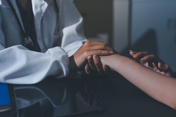 Fototapeta premium Male doctors shake hands with patients encouraging each other and praying for blessings. To offer love, concern, and encouragement while checking the patient's health. concept of medicine