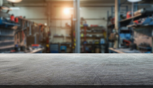 The interior of a car service center in the background and a scratched metal surface in the foreground