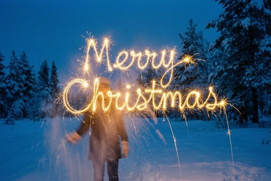 Merry Christmas Sparkler Light Writing in Winter Forest - Powered by Adobe