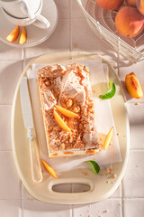 Sweet peach cheesecake made of fresh fruits and meringue.