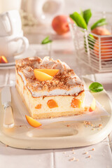 Sweet and homemade peach cheesecake with meringue, foam and fruits.