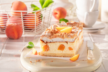 Delicious and tasty peach cheesecake freshly baked in the kitchen.