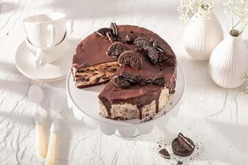 Homemade cheesecake with cookies and chocolate glaze.