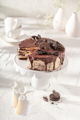 Tasty cheesecake with cookies and chocolate glaze.