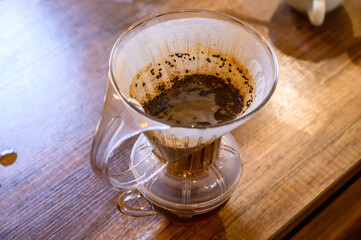 Pour over coffee brewing in glass dripper